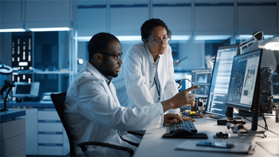 Research team reviewing chronotype data on lab monitors — population dataset analysis